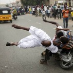 Supporters of the presidential candidate Muhammadu Buhari and his All Progressive Congress hits another supporter with a motorbike during celebrations in Kano