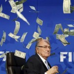 British comedian known as Lee Nelson (unseen) throws banknotes at FIFA President Blatter as he arrives for a news conference after the Extraordinary FIFA Executive Committee Meeting at the FIFA headquarters in Zurich