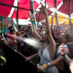 People are sprayed with water as they dance at the Coachella Valley Music and Arts Festival in Indio