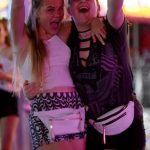 415AFE6B00000578-4606918-Two_girls_sporting_white_leather_bumbags_wave_their_arms_in_the_-m-7_1497525946424