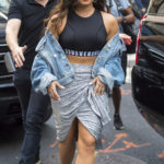 EXCLUSIVE: Demi Lovato wears a silver skirt and sports bra with denim jacket while leaving her hotel to go to Billboard Hot 100 in New York