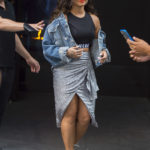 EXCLUSIVE: Demi Lovato wears a silver skirt and sports bra with denim jacket while leaving her hotel to go to Billboard Hot 100 in New York